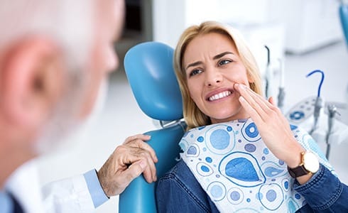Woman in dental chair during emergency dentistry visit