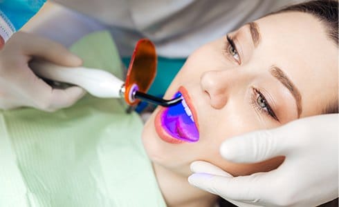 Woman receiving cosmetic dental bonding treatment