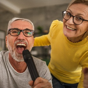 Seniors singing into a microphone