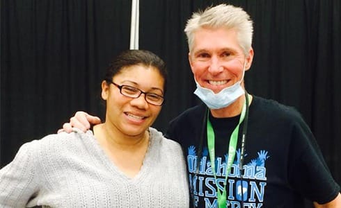 Doctor Hermen smiling with dental patient