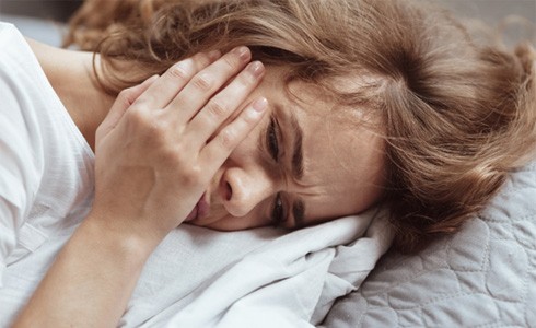 woman toothache in bed for root canal therapy in Oklahoma City 