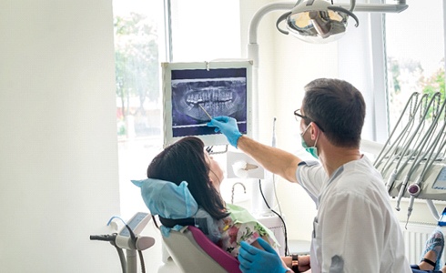 showing woman x-ray at dental exam in Oklahoma City