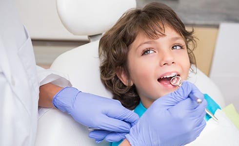 Child receiving dental checkup