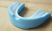 Closeup of a mouthguard to help prevent dental emergencies in Oklahoma City
