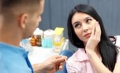 woman talking to her emergency dentist