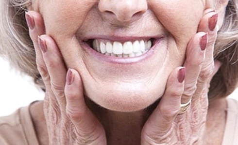 An up-close view of an older woman’s smile after learning the benefits of dental implants in Oklahoma City
