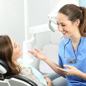 dental hygienist talking to a patient