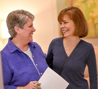 Dental team member smiling with a dental patient