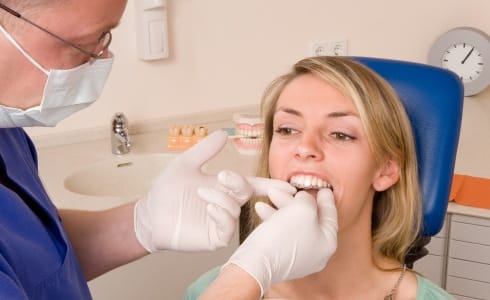 Dentist placing Invisalign tray