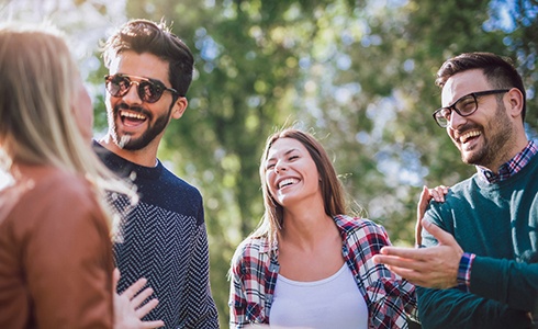 Group of people smiling and laughing together outside