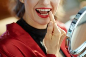 a person examining their gums 