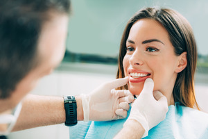 Dentist checking patient’s smile during a cosmetic consultation