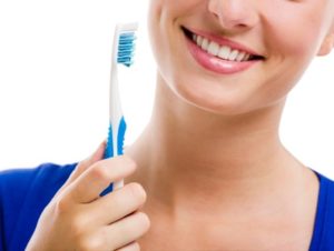 Close up of a woman holding a toothbrush