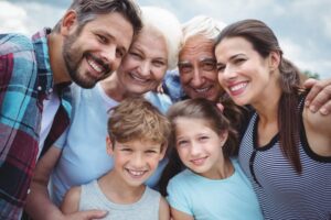 Three generations of a family smiling together